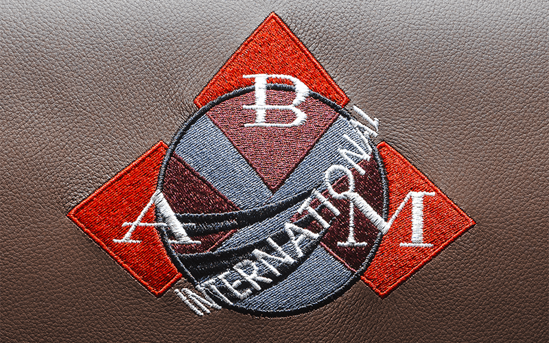 ABM International logo printed on a leather chair. 