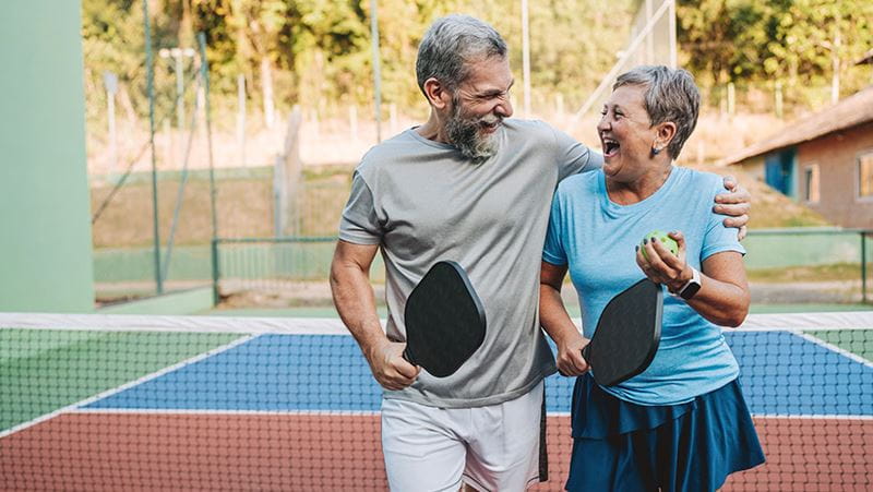 Senior couple playing pickleball