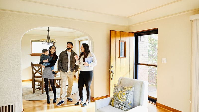 Family looking at home with a real estate agent.